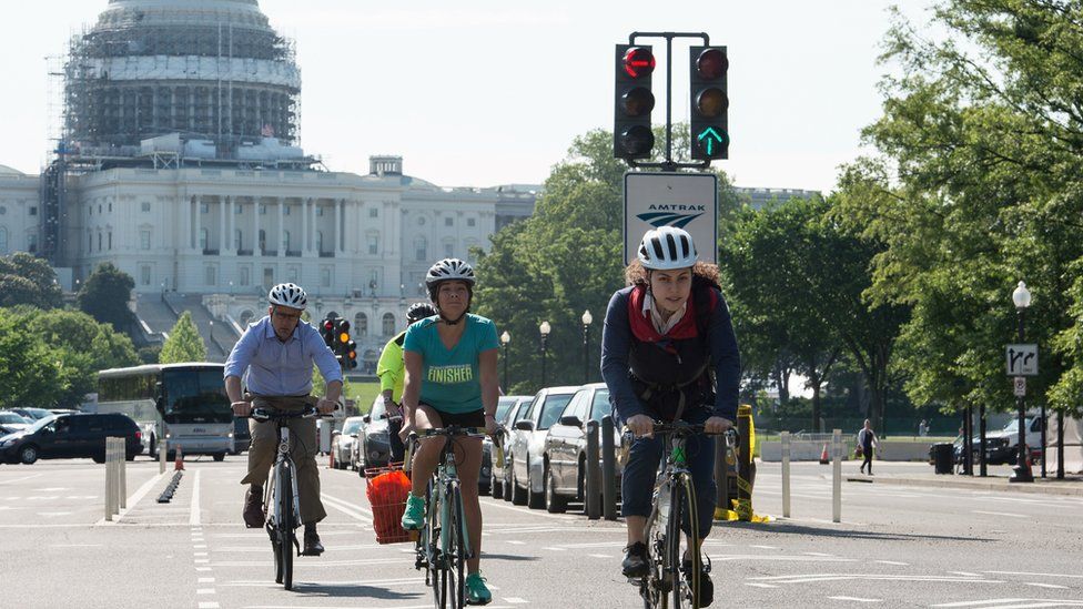 People ride bicycles past the US Capitol in Washington, DC, on May 24, 2016.