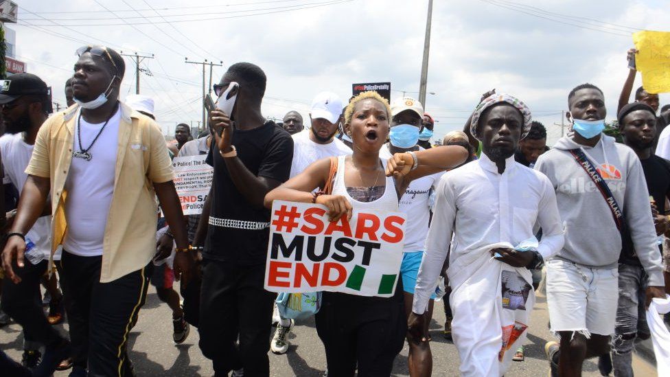 Youths of ENDSARS protesters display their placards in a crowd in support of the ongoing protest against the harassment, killings and brutality of The Nigerian Police Force Unit called Special Anti-Robbery Squad (SARS) at Allen Roundabout in Ikeja, on October 13, 2020.