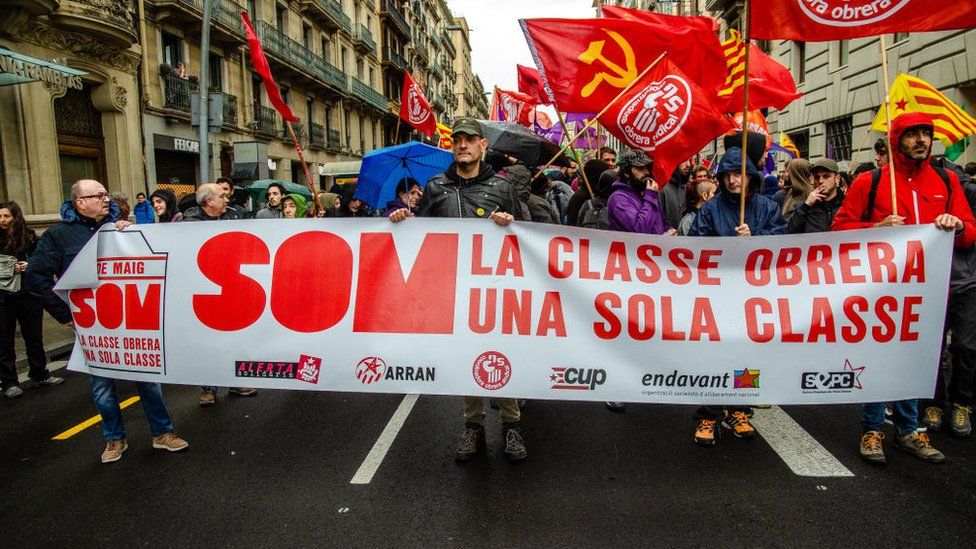 Protesters in Barcelona with a large banner reading "the working class one class" demonstrating against job insecurity, May 2018