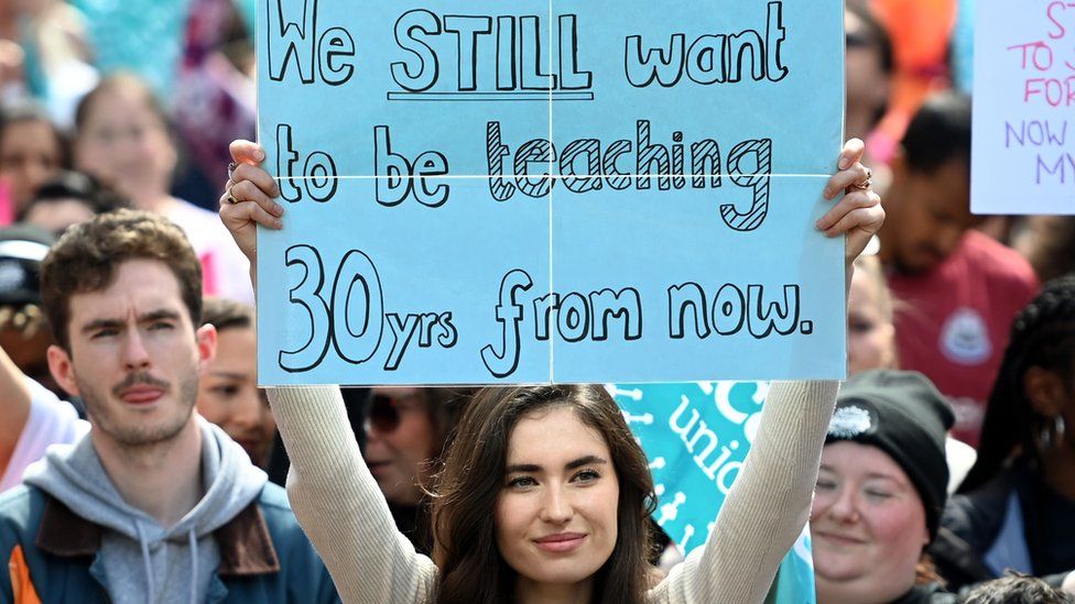 Striking teacher with placard