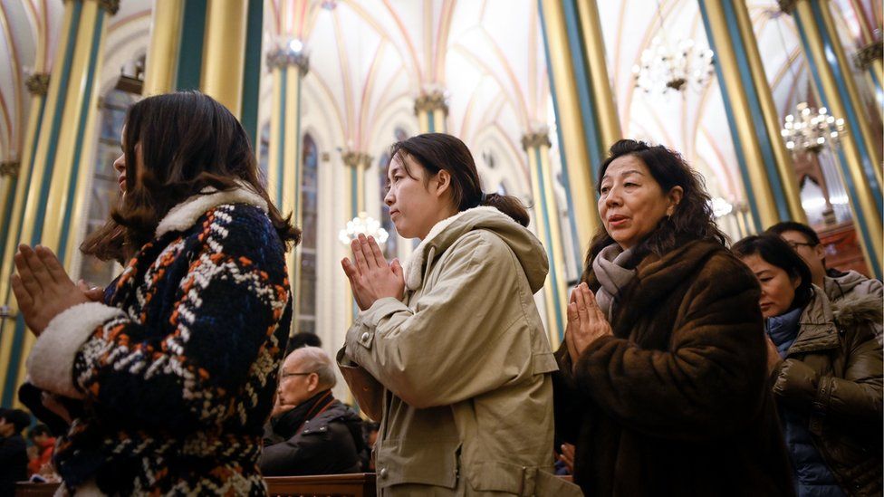Chinese worshippers attend a mass during the Christmas Eve at a Catholic church in Beijing on December 24, 2018.