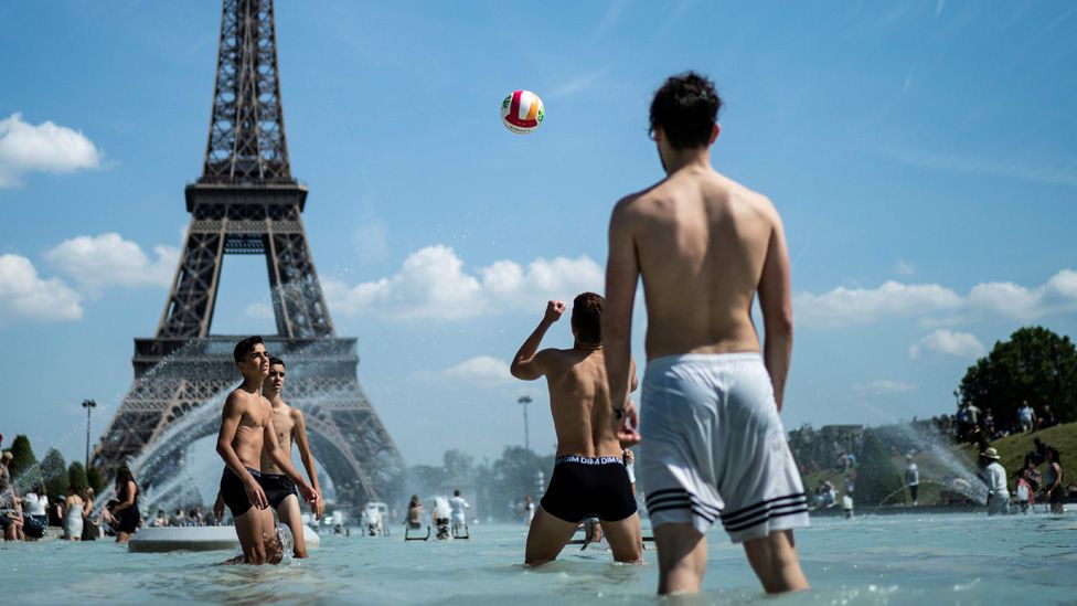 Youths playing in Trocadero fountain near Eiffel Tower, Paris, 25 June 19