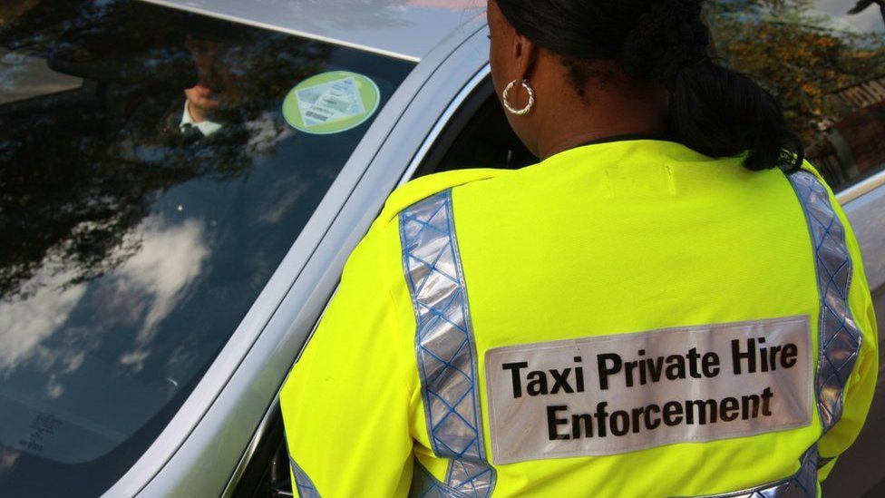 Taxi compliance officer and driver