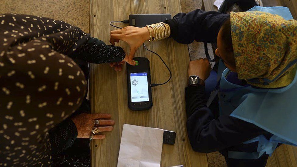 A fingerprint is read at a polling station