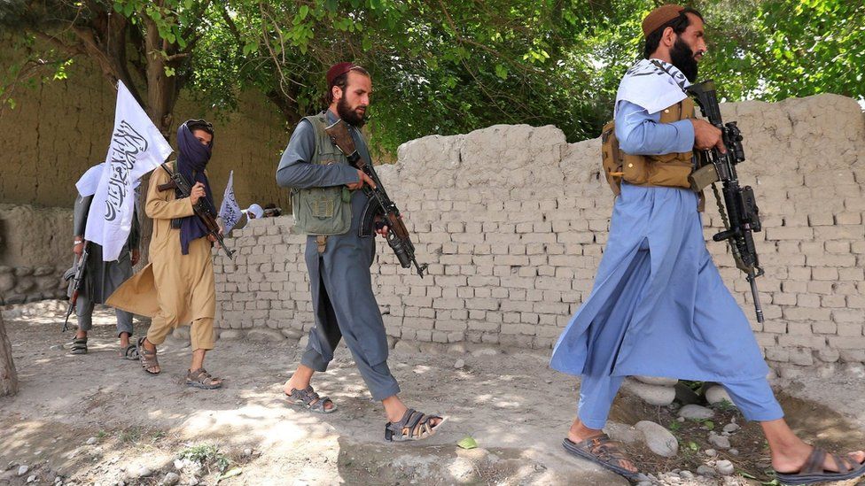 Taliban walk as they celebrate ceasefire in Ghanikhel district of Nangarhar province, Afghanistan June 16, 2018