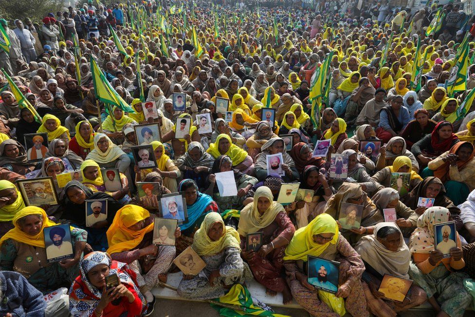 Widows and other female relatives of farmers who are believed to have killed themselves over debt attend a protest at the Tikri border near the Indian capital, Delhi, 16 December 2020