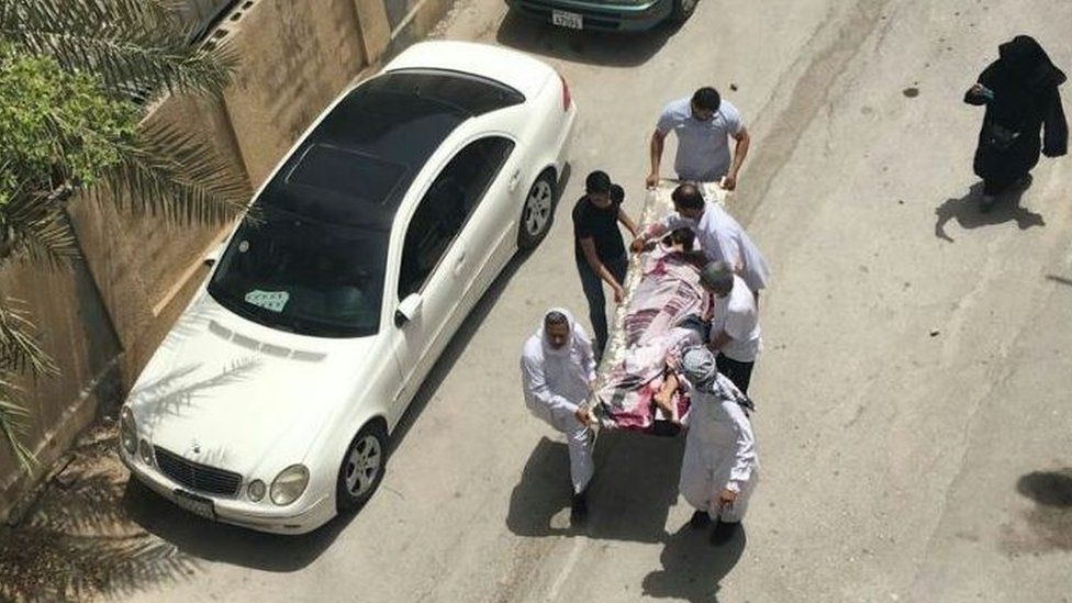 Photograph showing what activists say is an injured protester being carried on a stretcher after a police raid on a sit-in in Diraz on 23 May 2017