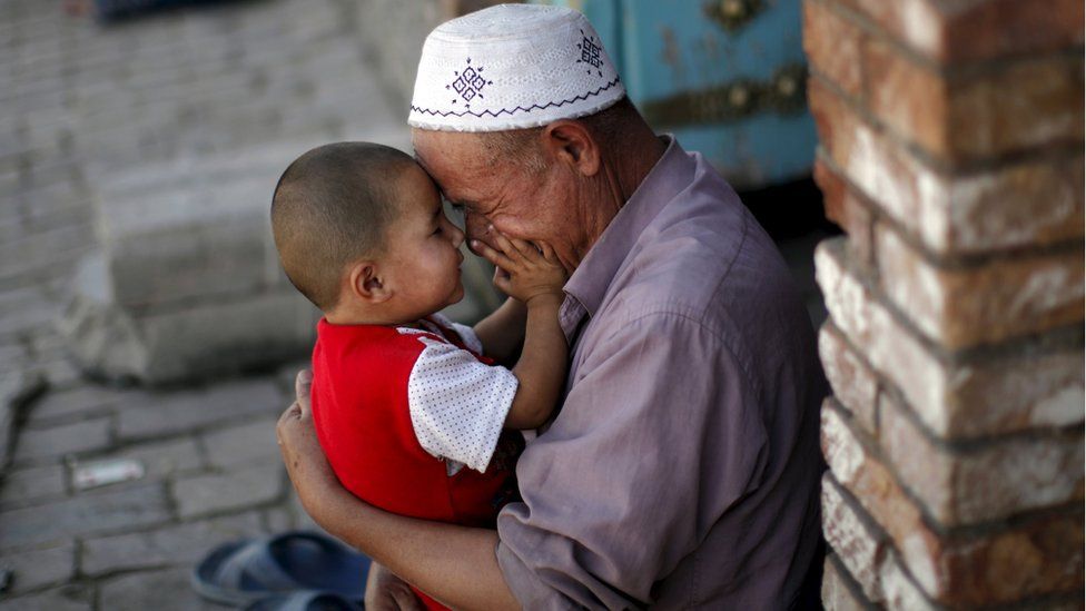 A Uighur man plays with a child in Kashgar, Xinjiang, China (file image)