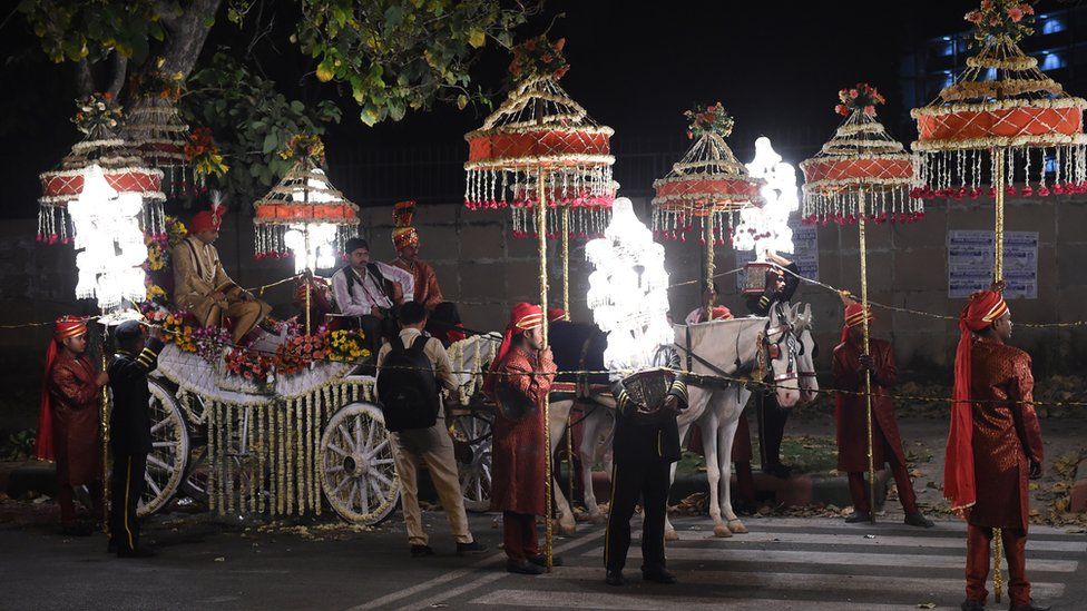 A groom sits on a horse cart during a wedding procession in New Delhi on April 21, 2015.