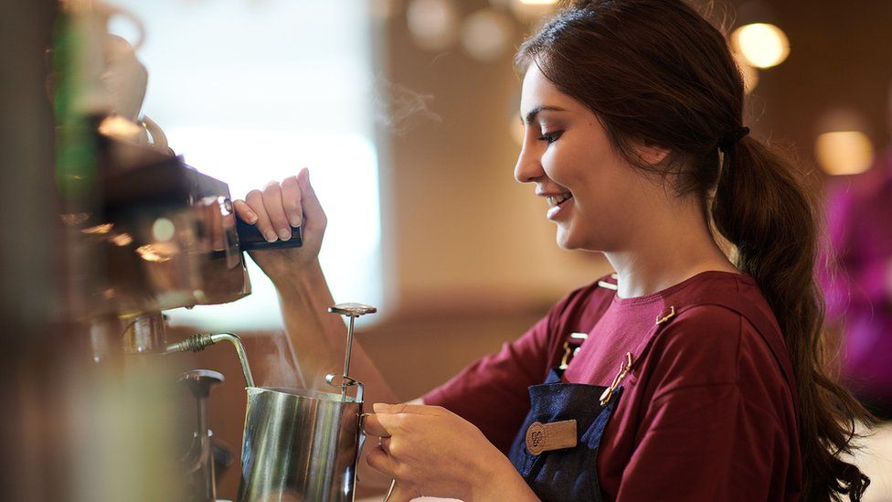 A Costa Coffee barista making a drink