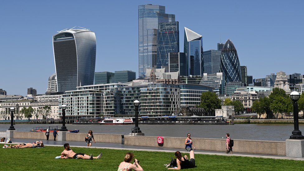 People enjoy the hot weather in by the river Thames in London, Britain