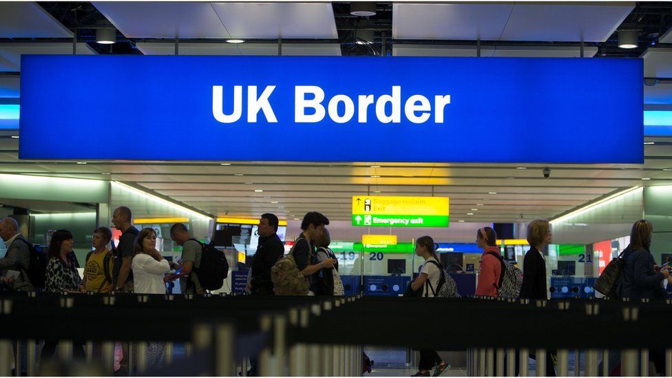 File photo from 2014 showing passengers passing through border controls at Heathrow Airport.