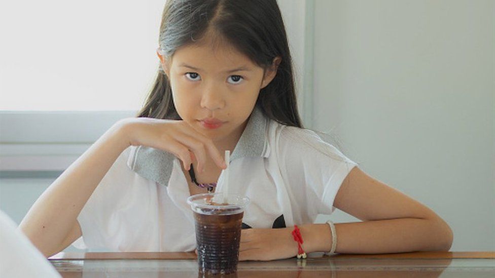 girl drinking fizzy drink