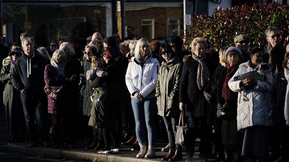 Members of the public line the street near to Iveagh Hall, in Leigh-on-Sea, the constituency office of murdered MP Sir David Amess, as they wait to pay their respects