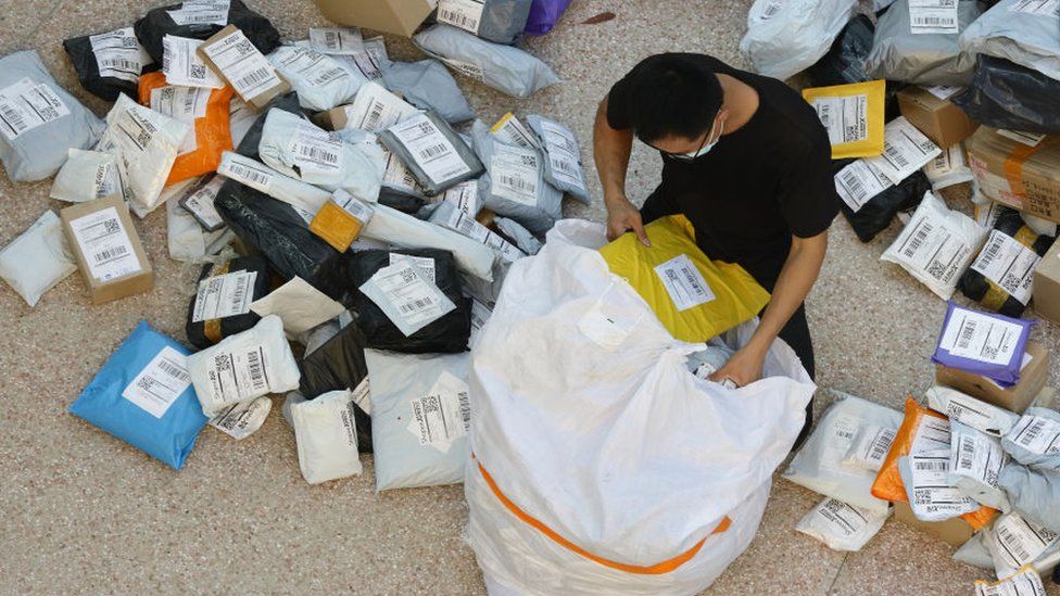 A courier prepares parcels for delivery