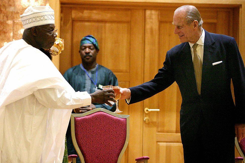 Nigerian President Olusegun Obasanjotoasts with Prince Philip, Duke of Edinburgh, during a reception in honour of Britain's Queen Elizabeth II at the State House in Abuja, Nigeria, 3 December 2003.