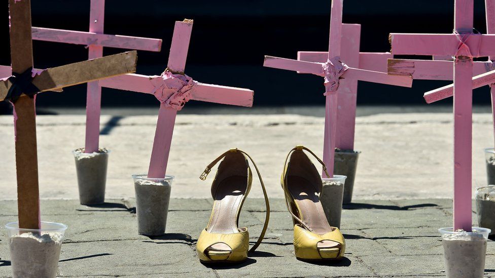 A pair of high heeled shoes in the middle of pink crosses