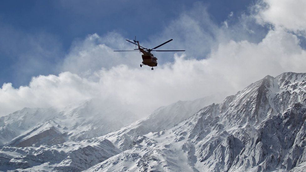 A rescue team helicopter searches for the wreckage of Aseman Airlines flight EP3704 in Iran's Zagros mountain range, 19 February