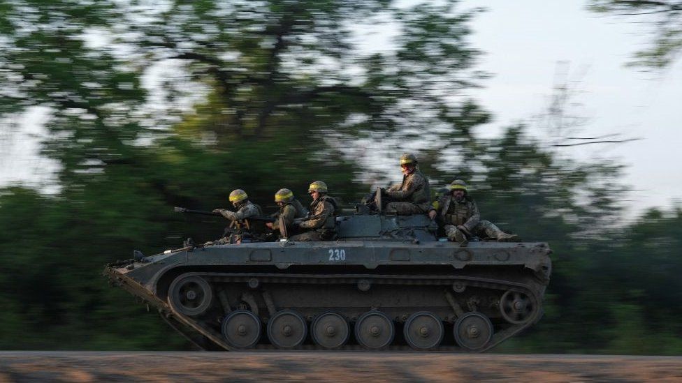 Ukrainian soldiers ride on a BMP infantry fighting vehicle toward Bakhmut on 20 May