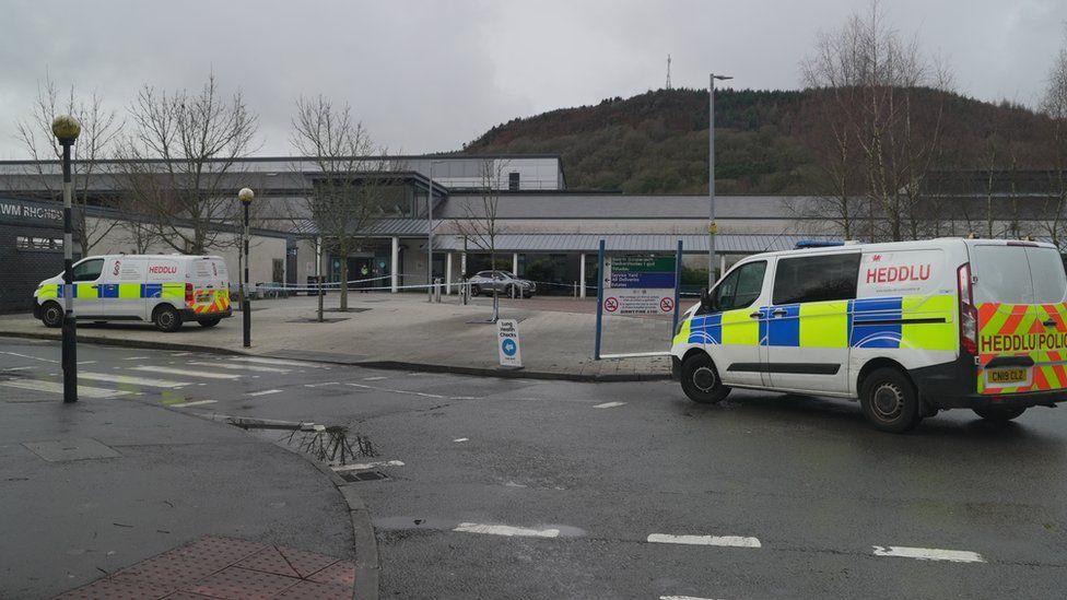 Ysbyty Cwm Rhondda Hospital car park with police vans