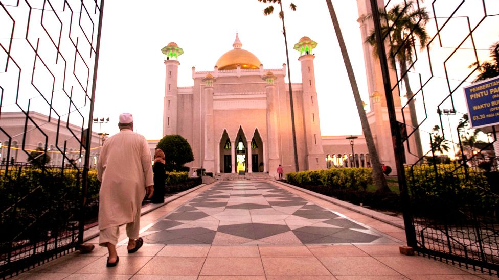 A Muslim man walks inside the Sultan Omar Ali Saifuddien mosque to perform the sunset prayer in Bandar Seri Begawan, Brunei, 01 April 2019