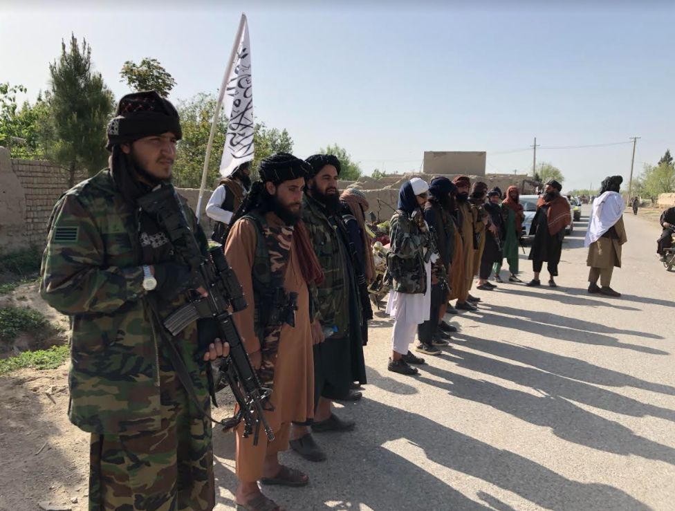 Taliban fighters by a checkpoint