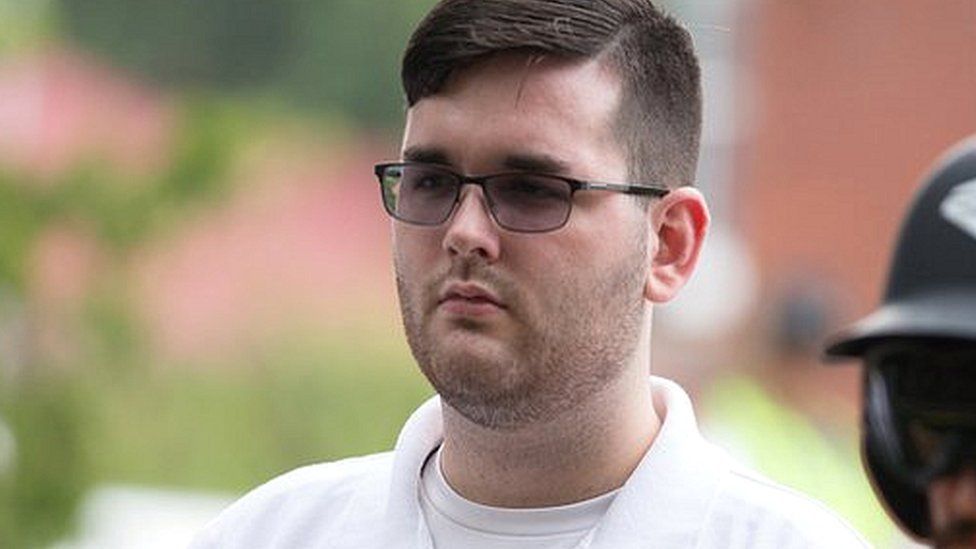 James Alex Fields Jr pictured at "Unite the right" rally before the car attack. Standing in a white polo shirt.