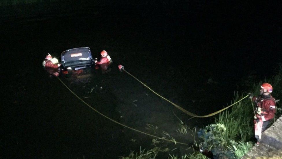 Car being removed from river