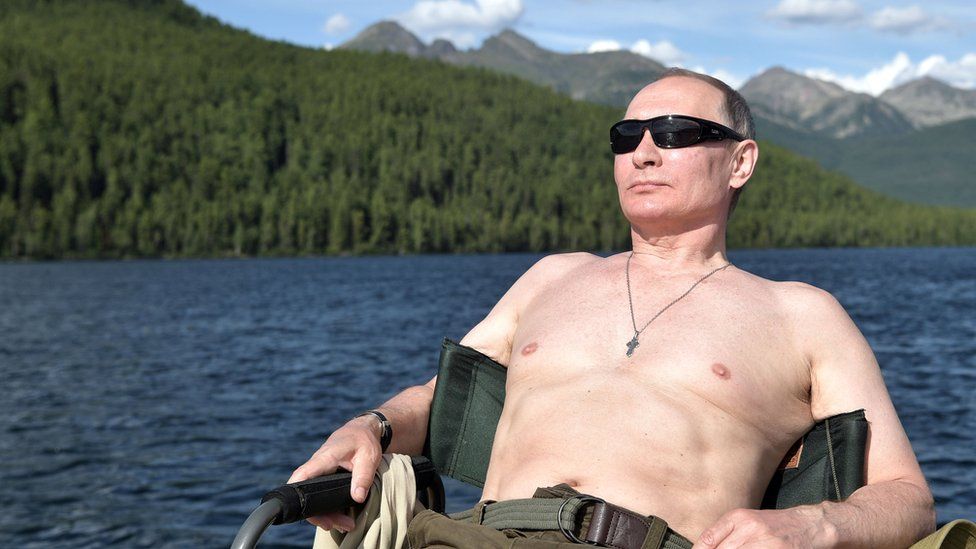 Russian President Vladimir Putin relaxes after fishing during the hunting and fishing trip which took place on August 1-3 in the republic of Tyva in southern Siberia