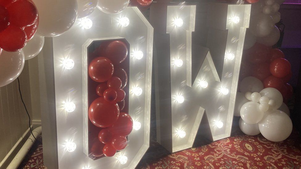 3ft-high lit-up letters O and W surrounded by red and white balloons - the colours of Owen's World