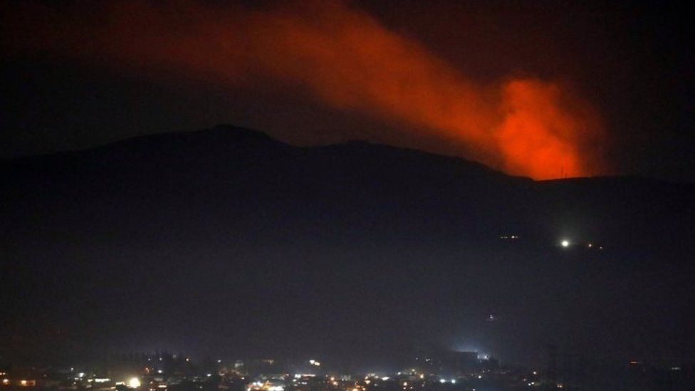 Smoke rises past a mountain near Damascus, Syria. Photo: 25 December 2018