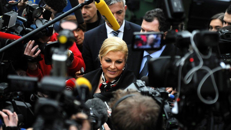 Reporters surround Croatia's president Kolinda Grabar-Kitarovic