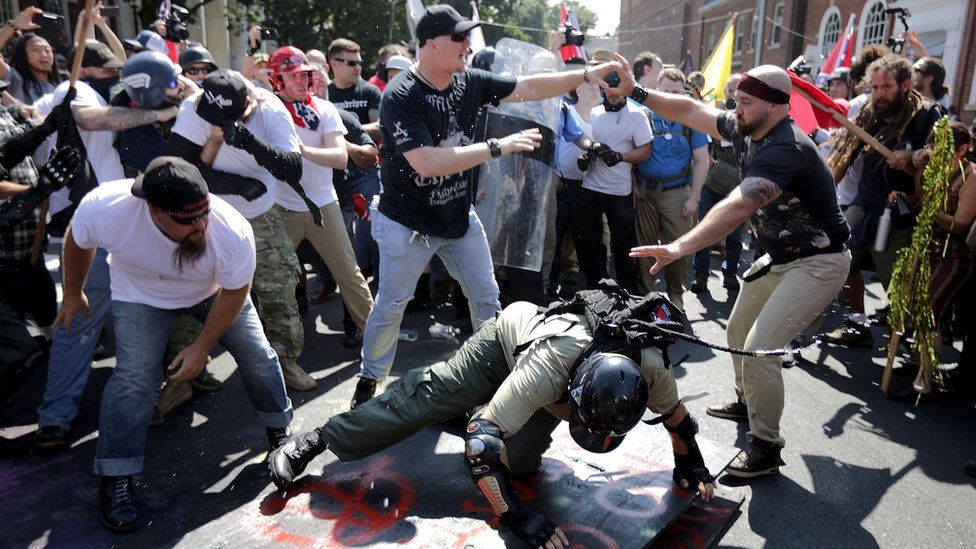 Members of the "alt-right" clash with counter-protesters as they enter Lee Park during the "Unite the Right" rally August 12, 2017 in Charlottesville