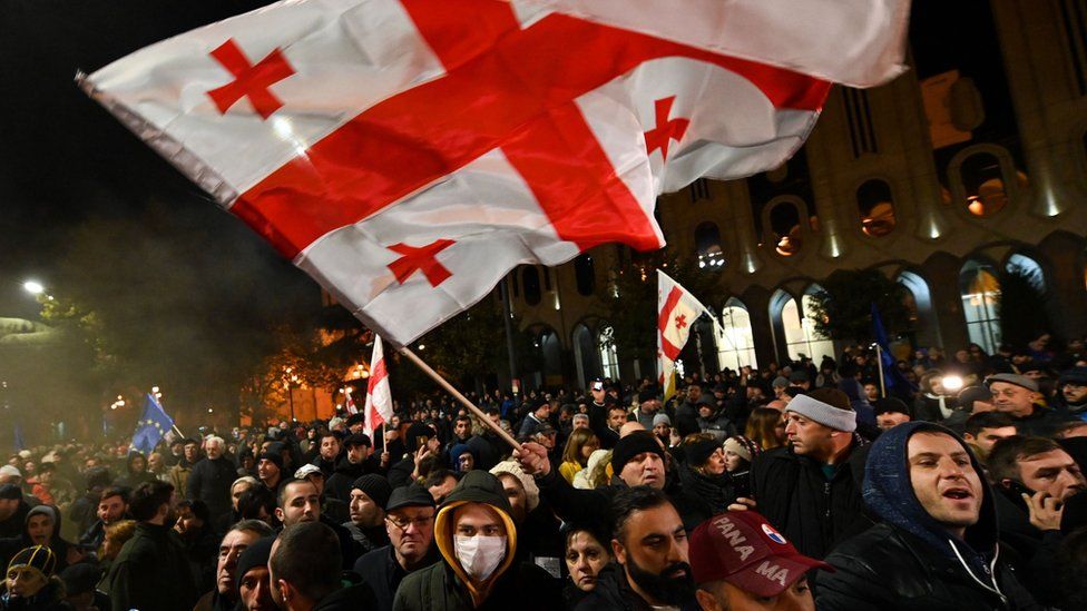 Protesters waving a Georgian flag in Tbilisi