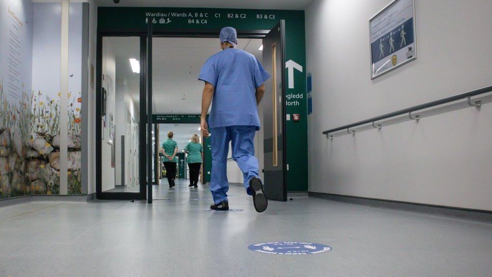 Staff walking along a corridor at Grange Hospital, Cwmbran