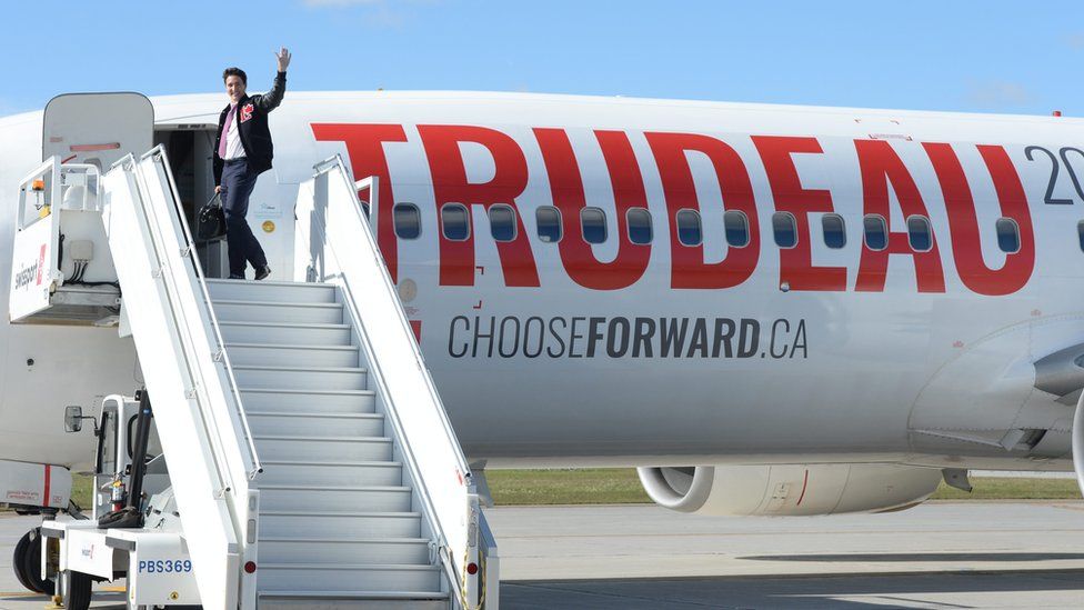 Liberal leader Justin Trudeau enters one of his campaign planes