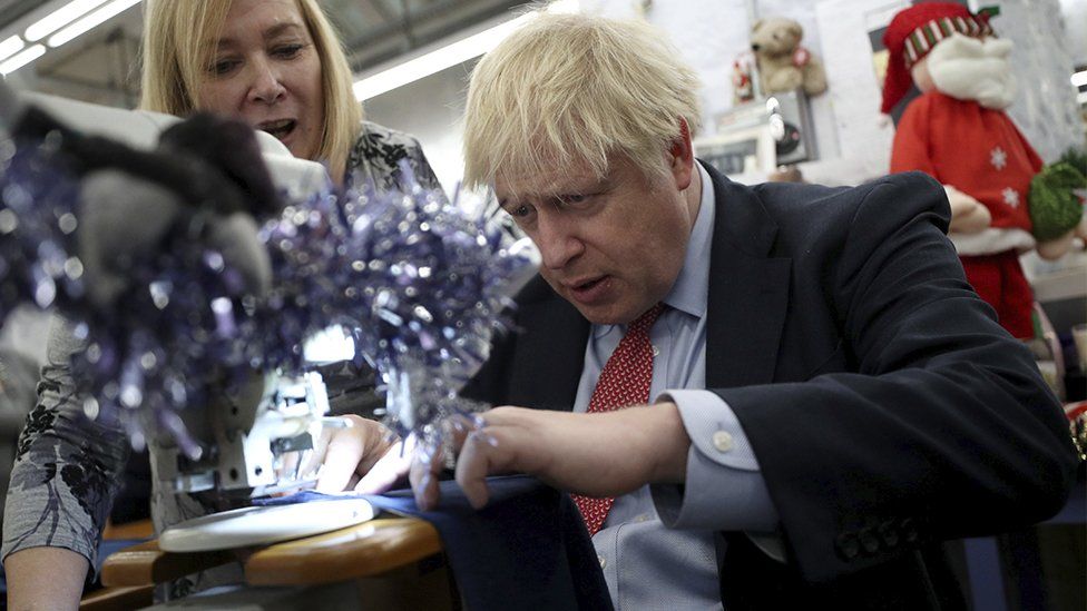Boris Johnson using a sewing machine