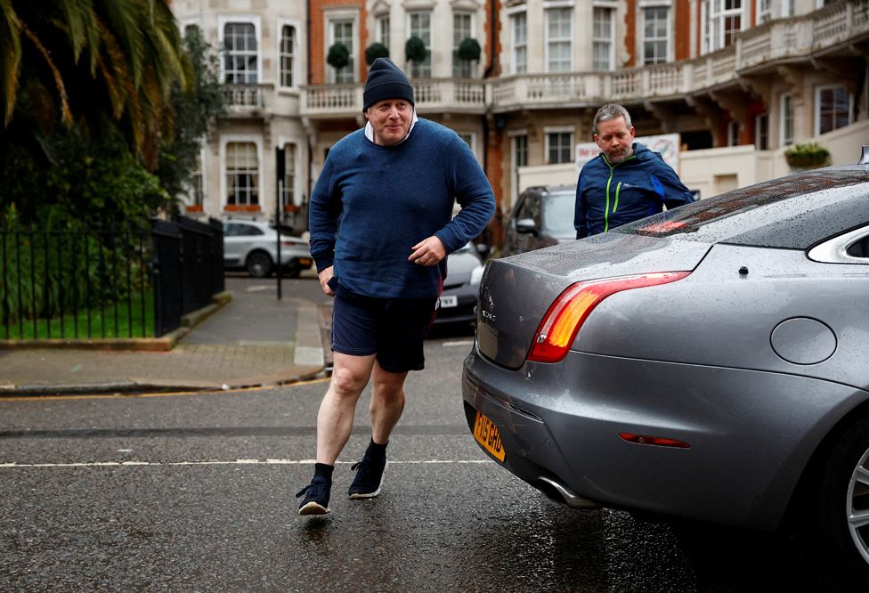 Former British Prime Minister Boris Johnson walks home after his morning run, in London, Britain March 21, 2023.