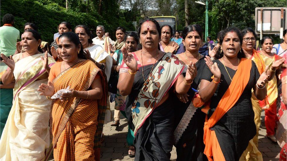 Hindu women devotees and activists shout slogans praising the Hindu God Ayyapa during a protest against the Supreme Court verdict revoking a ban on women's entry to the Sabarimala temple.