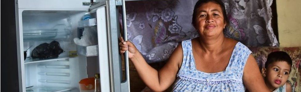 Liliana Rojas shows her empty refrigerator at her home in the poor neighbourhood of Catia, Caracas, June 2, 2016.