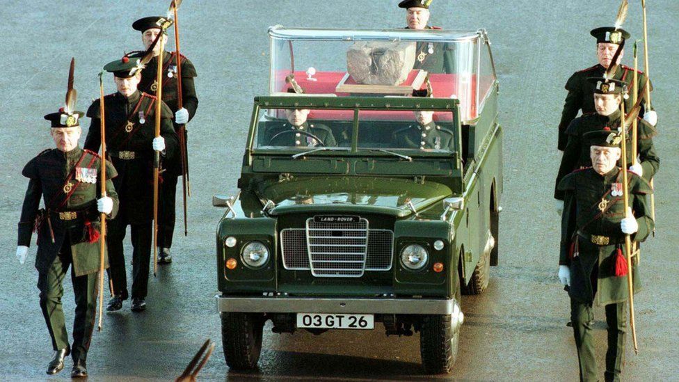 Members of the Royal Archers escort Army land rover carrying the Stone of Destiny across Edinburgh Castle esplanade