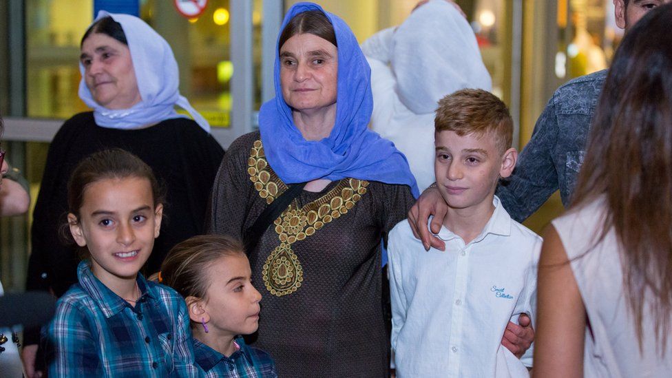 Imad Mishko Tammo, in white, twelve-year-old Yazidi boy, is reunited with his mother.
