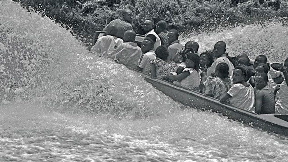 A photo by Sunmi Smart-Cole entitled: "Stormy Times In The Niger Delta" - 2006, showing people on a speedboat in the Niger Delta, Nigeria