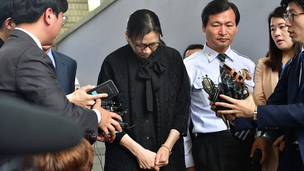 Heather Cho outside court in handcuffs