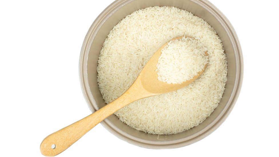 Pot of rice with a wooden spoon