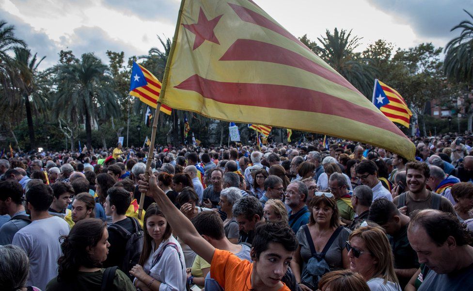 People gather to hear Catalan President Carles Puigdemont speak on October 10, 2017 in Barcelona