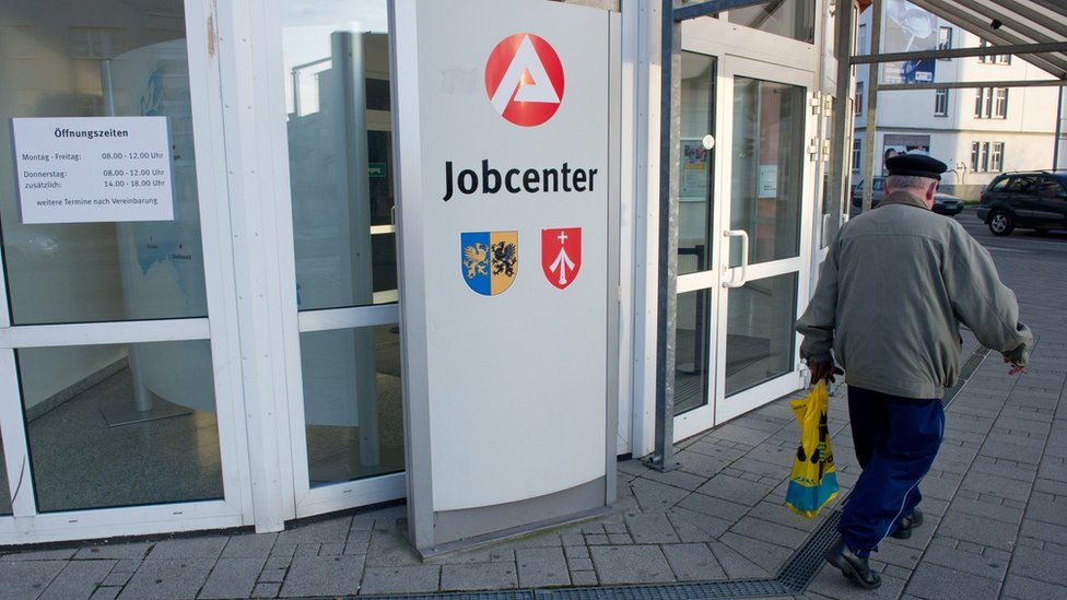 A man walks past an unemployment office