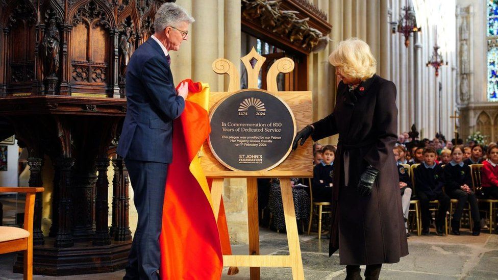 Queen Camilla unveiling a plaque during the service of celebration