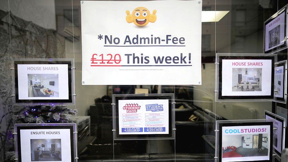 A letting agents window advertises a 'No Admin Fee' promotion