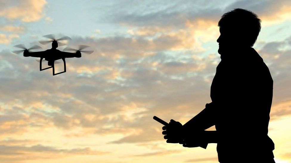 A generic image of a person flying a drone